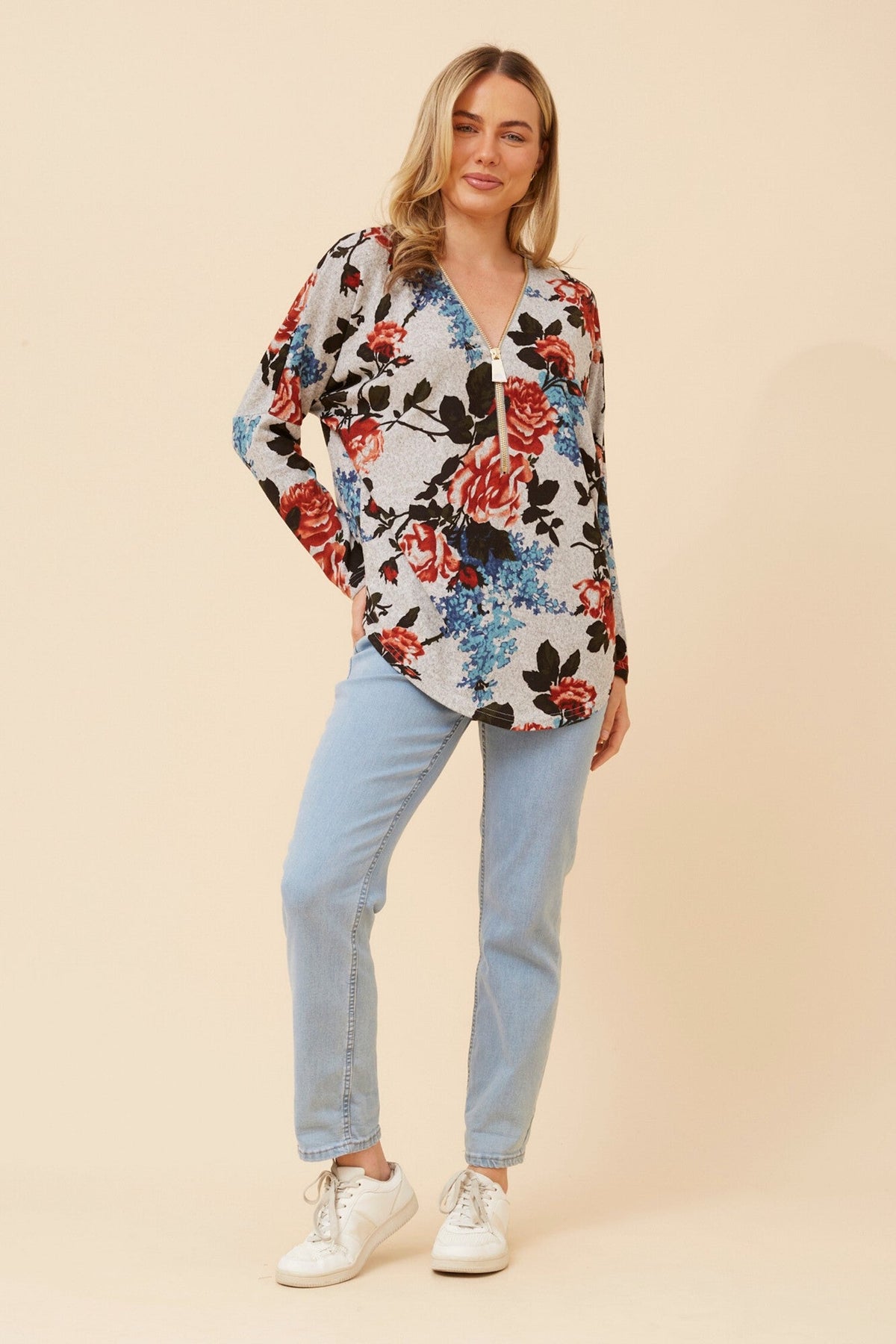 Image of a model wearing Tops. Product name - SUVI FLORAL PRINT TOP in Multi Orange colour by brand - Caroline Morgan Australia