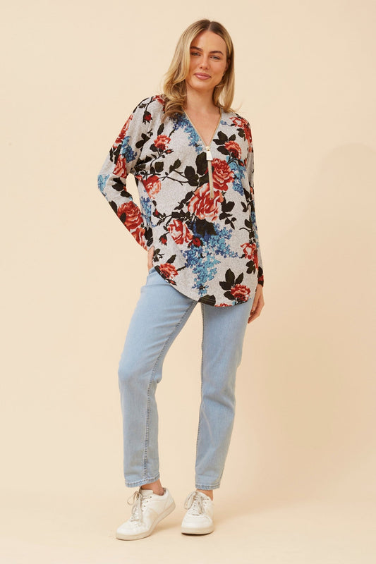 Image of a model wearing Tops. Product name - SUVI FLORAL PRINT TOP in Multi Orange colour by brand - Caroline Morgan Australia