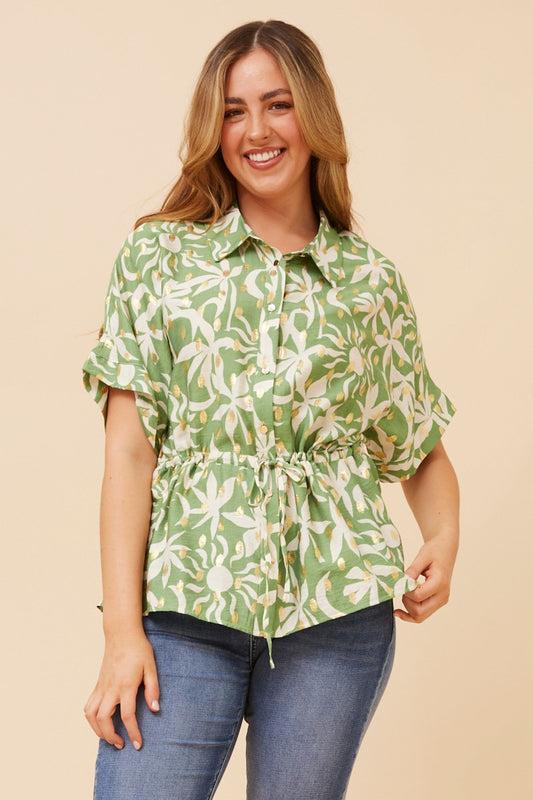 Image of a model wearing Tops. Product name - KAORU FOIL PRINT TOP in Sage colour by brand - Caroline Morgan Australia