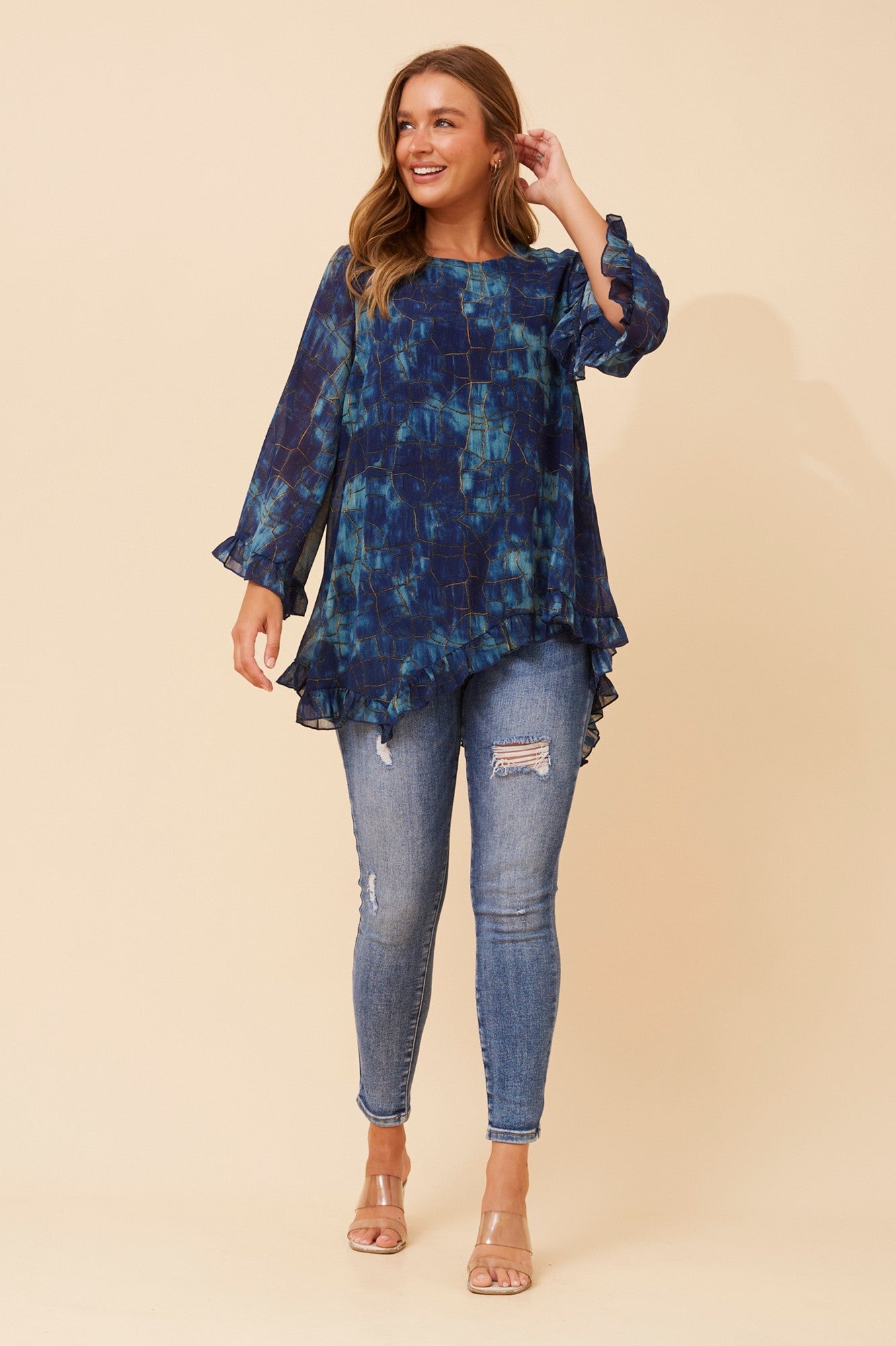 Image of a model wearing Tops. Product name - WANDIN ABSTRACT PRINT TOP in Teal colour by brand - Caroline Morgan Australia