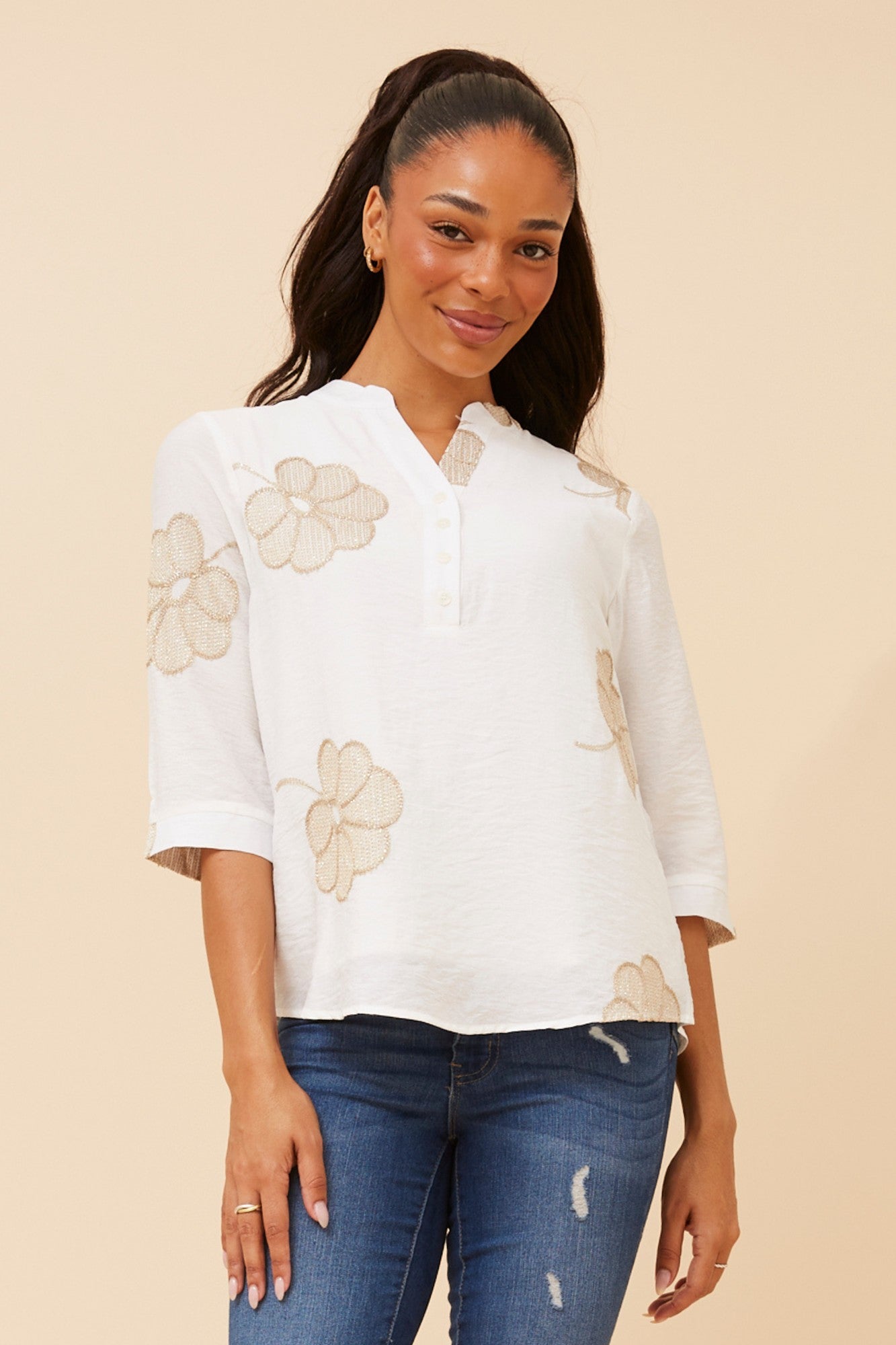 Image of a model wearing Tops. Product name - NORNAH EMBROIDERED TOP in White colour by brand - Caroline Morgan Australia