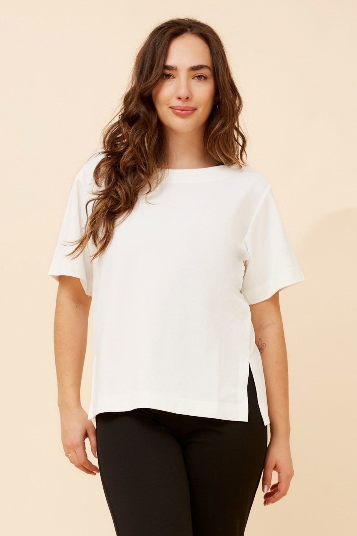 Image of a model wearing Tops. Product name - HARWIN SOLID TOP in Black colour by brand - Caroline Morgan Australia