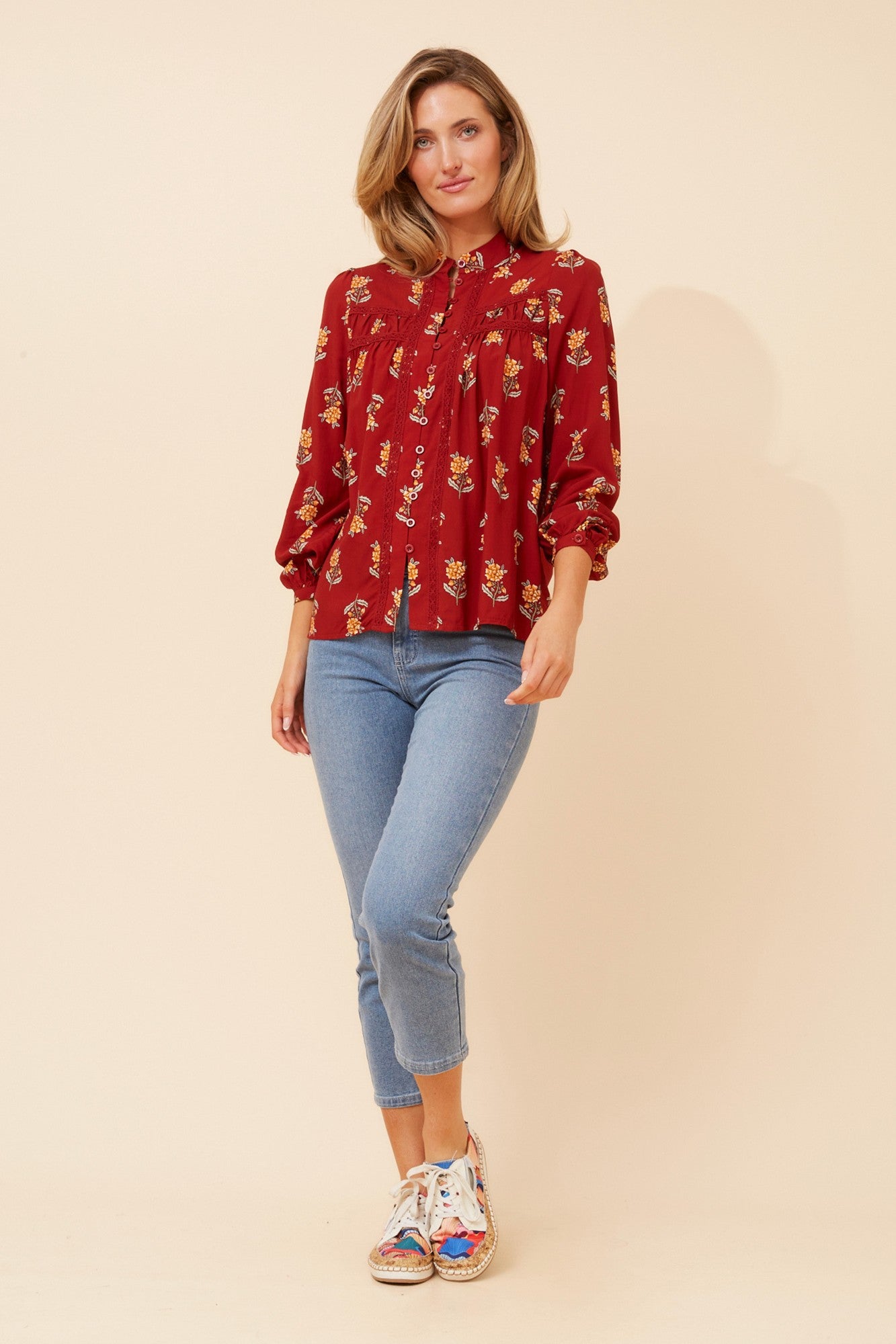 Image of a model wearing Tops. Product name - PAVITRA FLORAL TOP in Rust colour by brand - Caroline Morgan Australia