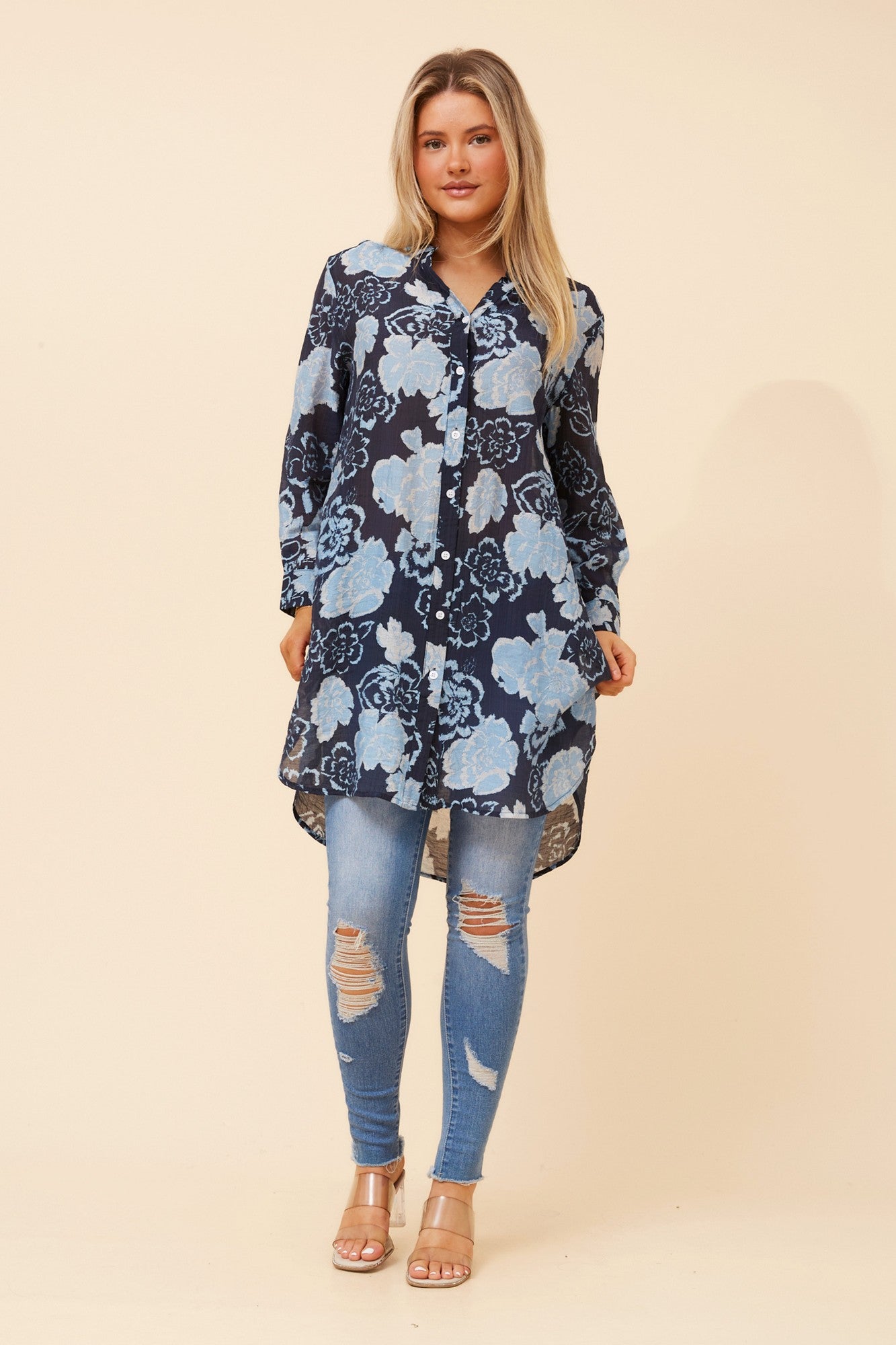 Image of a model wearing Outerwear. Product name - JANSON FLORAL TUNIC SHIRT in Navy colour by brand - Caroline Morgan Australia