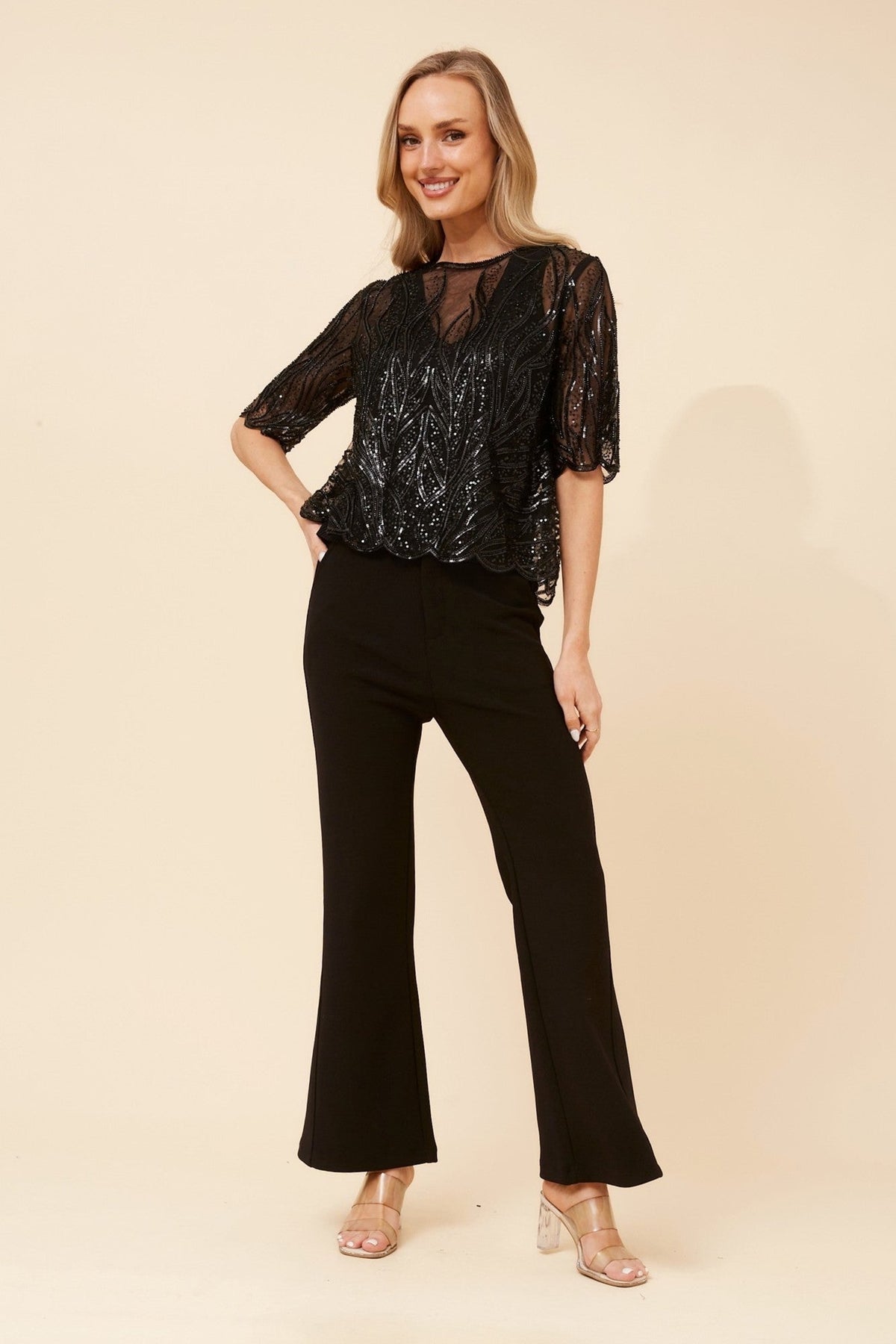 Image of a model wearing Tops. Product name - LINDEN SEQUIN TOP in Black colour by brand - Caroline Morgan Australia