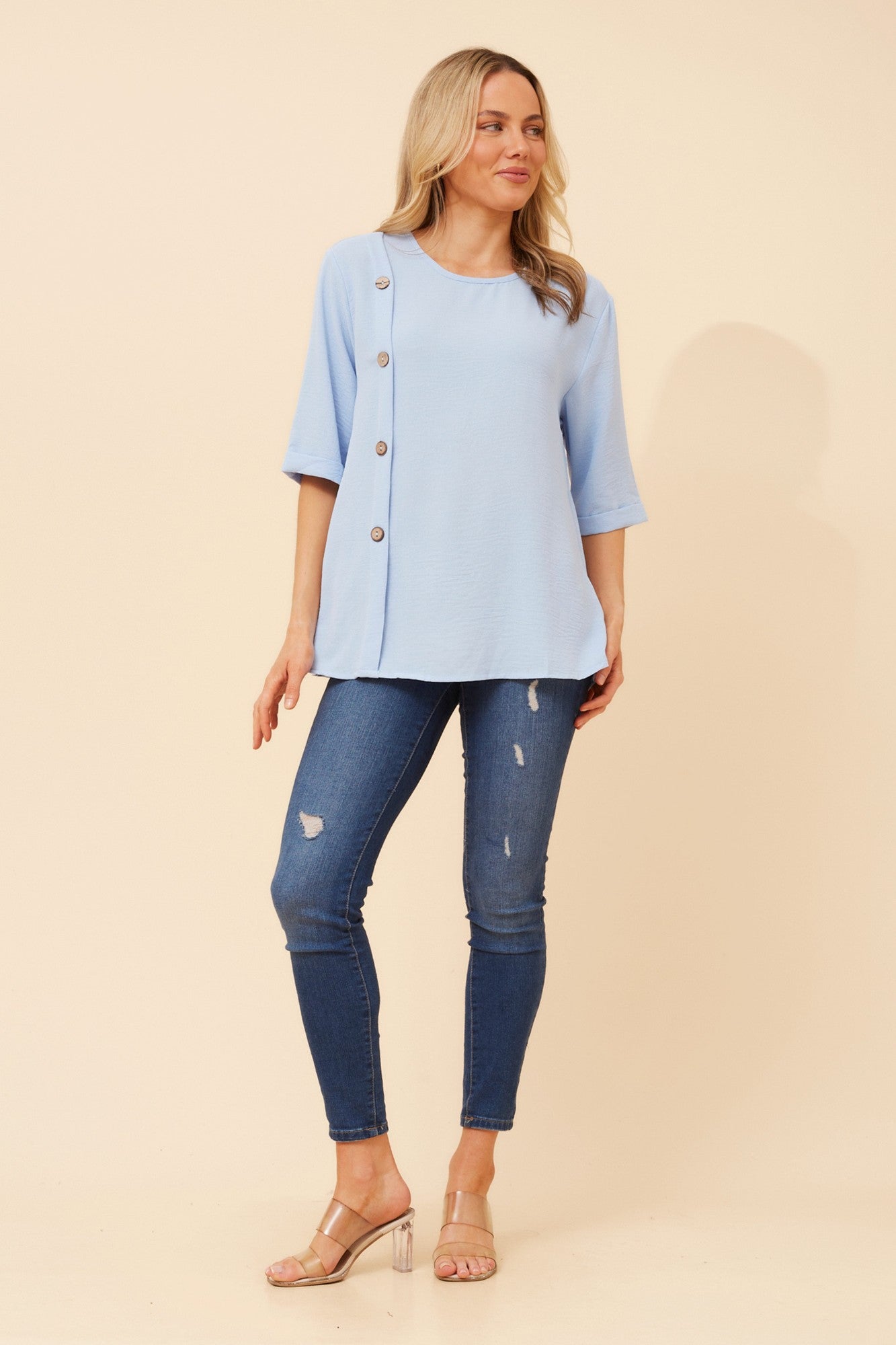 Image of a model wearing Tops. Product name - TAI SOLID TOP in Blue colour by brand - Caroline Morgan Australia