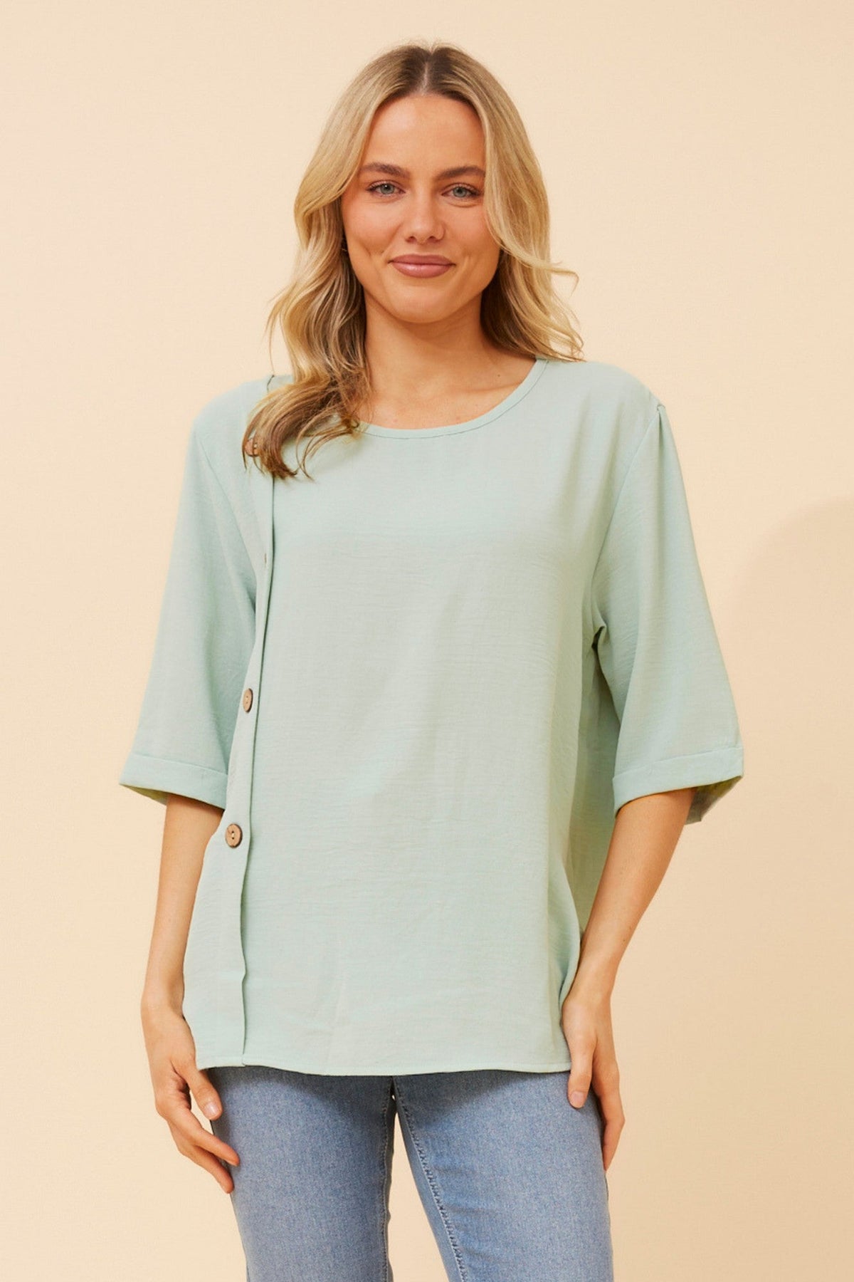 Image of a model wearing Tops. Product name - TAI SOLID TOP in Mint colour by brand - Caroline Morgan Australia