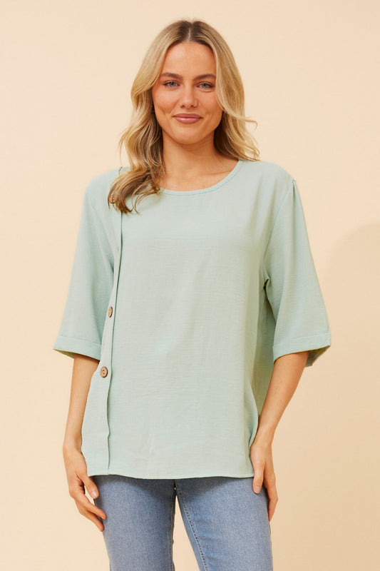 Image of a model wearing Tops. Product name - TAI SOLID TOP in Mint colour by brand - Caroline Morgan Australia
