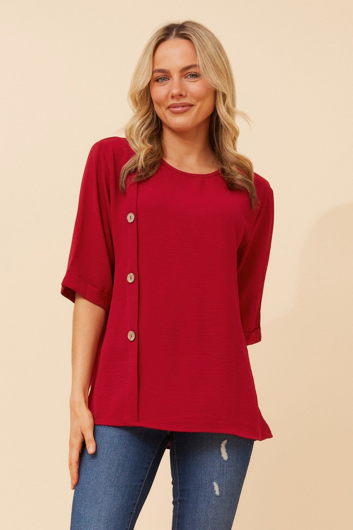 Image of a model wearing Tops. Product name - TAI SOLID TOP in Rich Red colour by brand - Caroline Morgan Australia