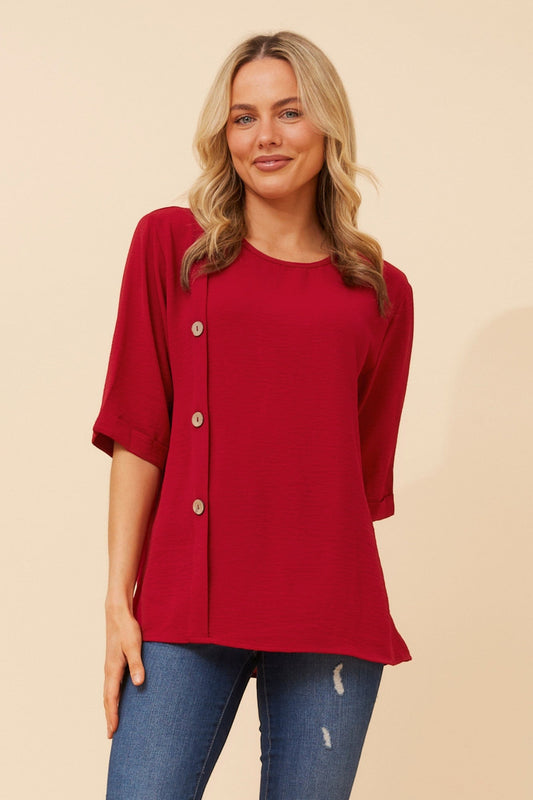 Image of a model wearing Tops. Product name - TAI SOLID TOP in Rich Red colour by brand - Caroline Morgan Australia