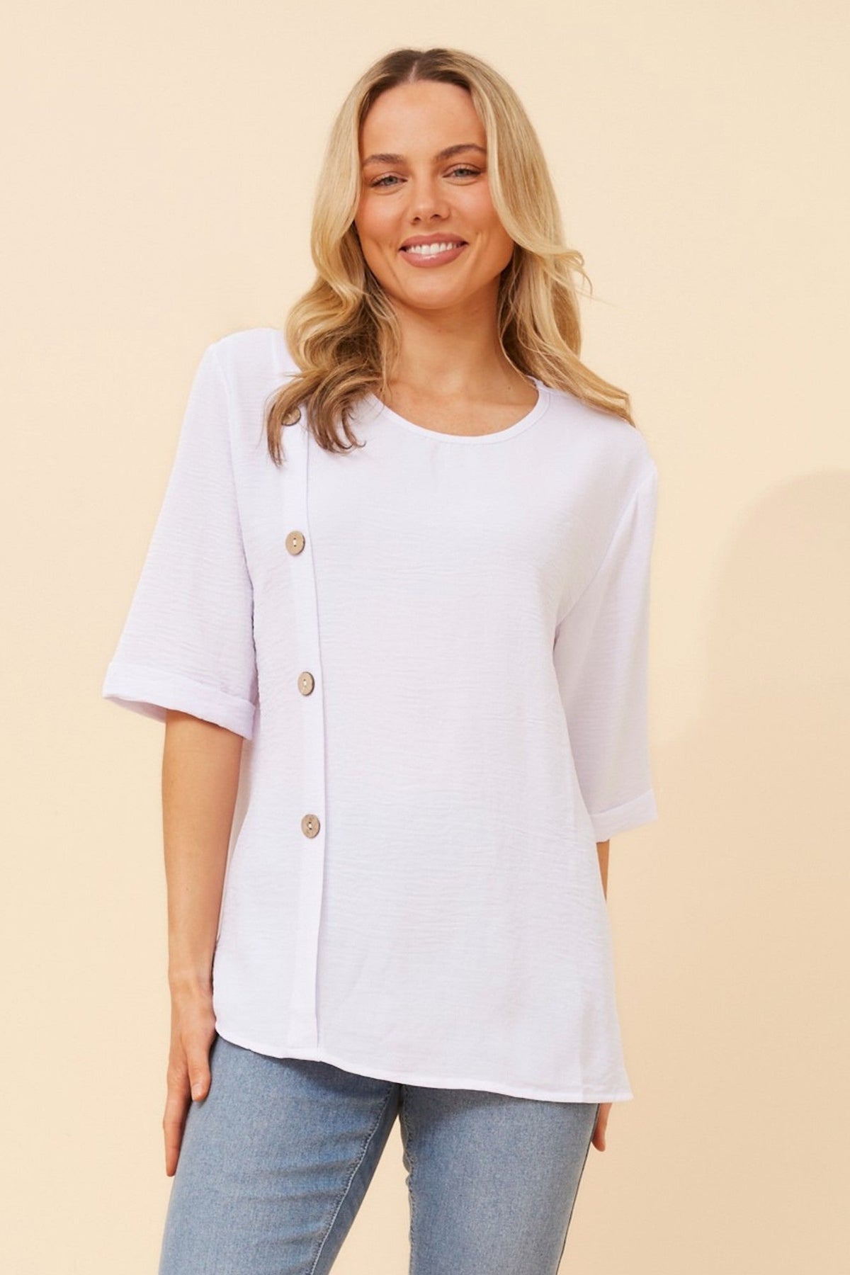 Image of a model wearing Tops. Product name - TAI SOLID TOP in White colour by brand - Caroline Morgan Australia