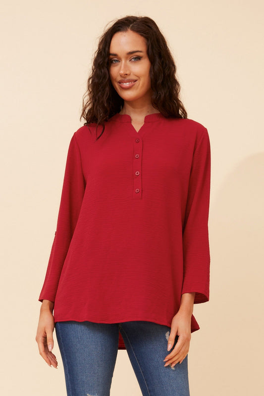Image of a model wearing Tops. Product name - NEOMA SOLID TOP in Teal colour by brand - Caroline Morgan Australia