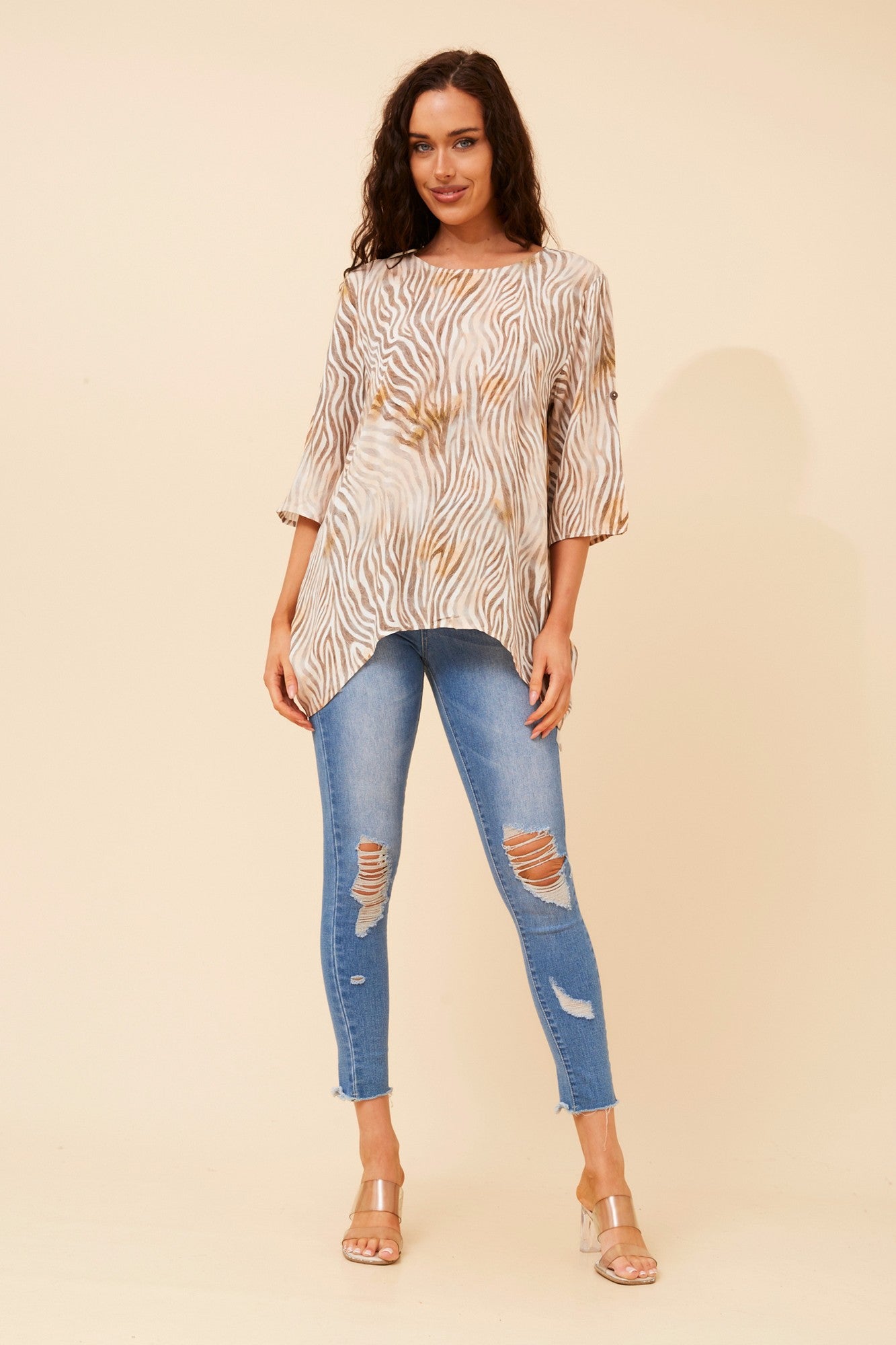 Image of a model wearing Tops. Product name - PREITA ANIMAL PRINT TOP in Multi Beige colour by brand - Caroline Morgan Australia