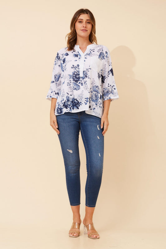 Image of a model wearing Tops. Product name - ROSETTA FLORAL TOP in Multi Blue colour by brand - Caroline Morgan Australia