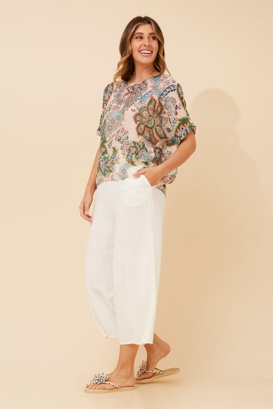 Image of a model wearing Tops. Product name - HENDRIX FLORAL TOP in Multi Blue colour by brand - Caroline Morgan Australia