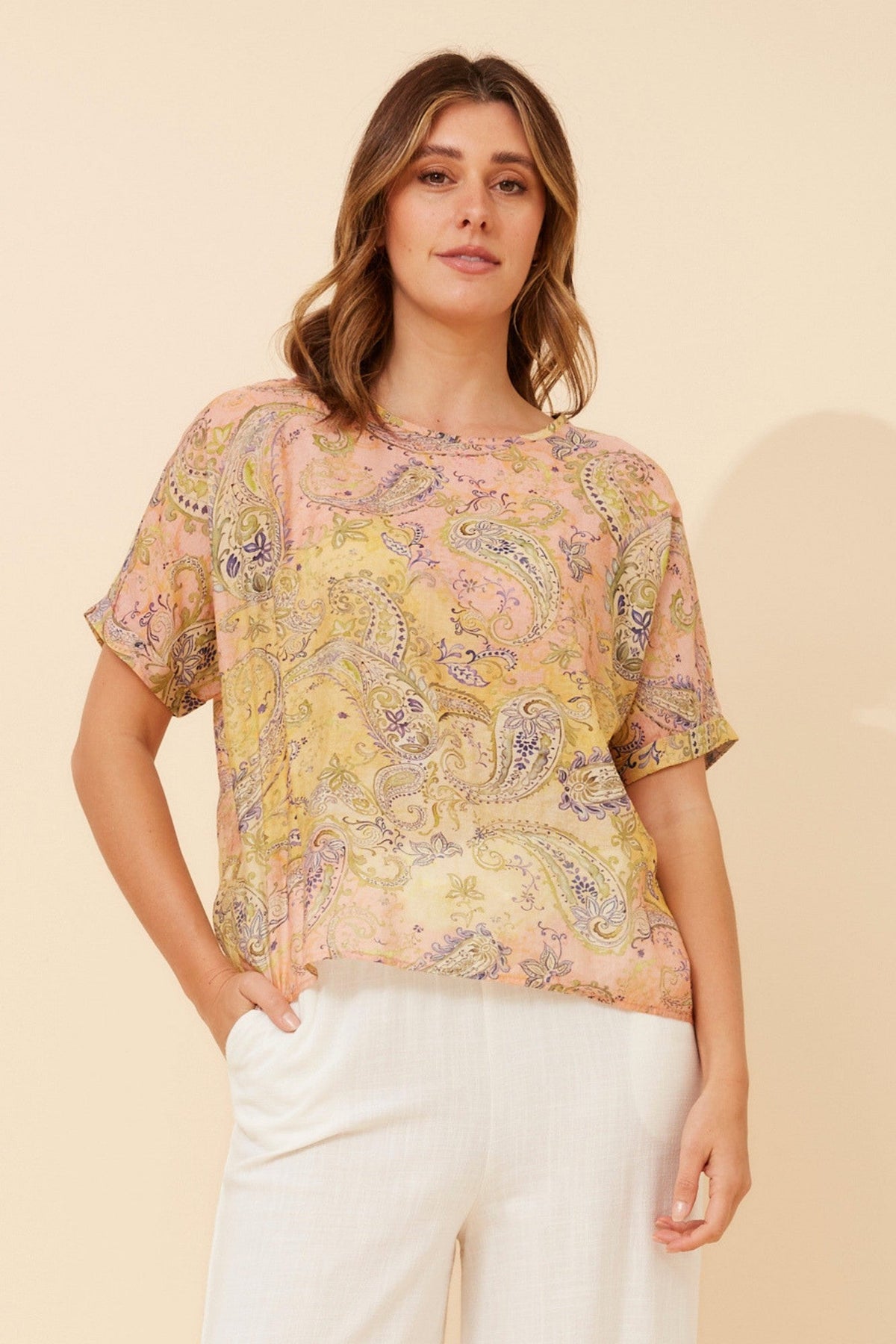 Image of a model wearing Tops. Product name - HENDRIX PAISLEY PRINT TOP in Multi Pink colour by brand - Caroline Morgan Australia