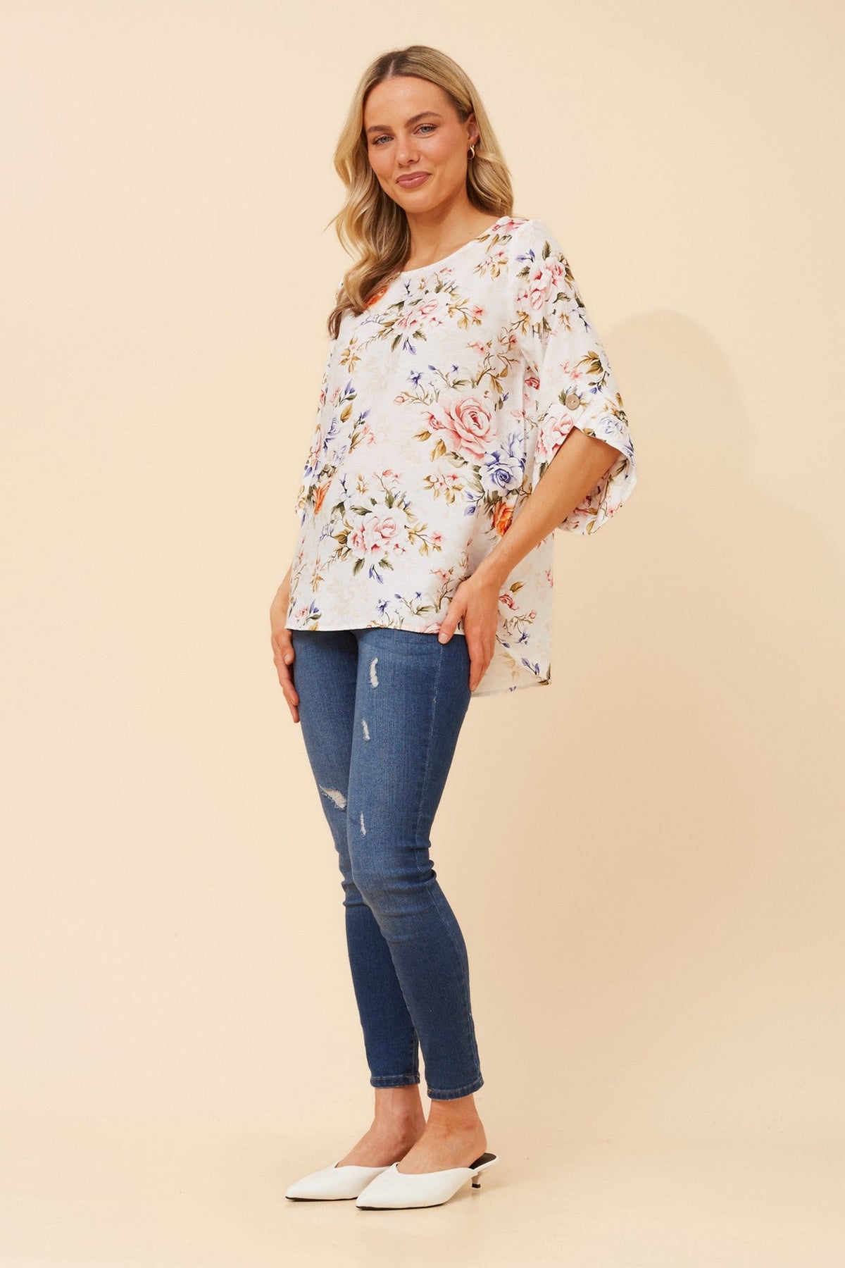 Image of a model wearing Tops. Product name - SAMANTHA FLORAL TOP in White colour by brand - Caroline Morgan Australia