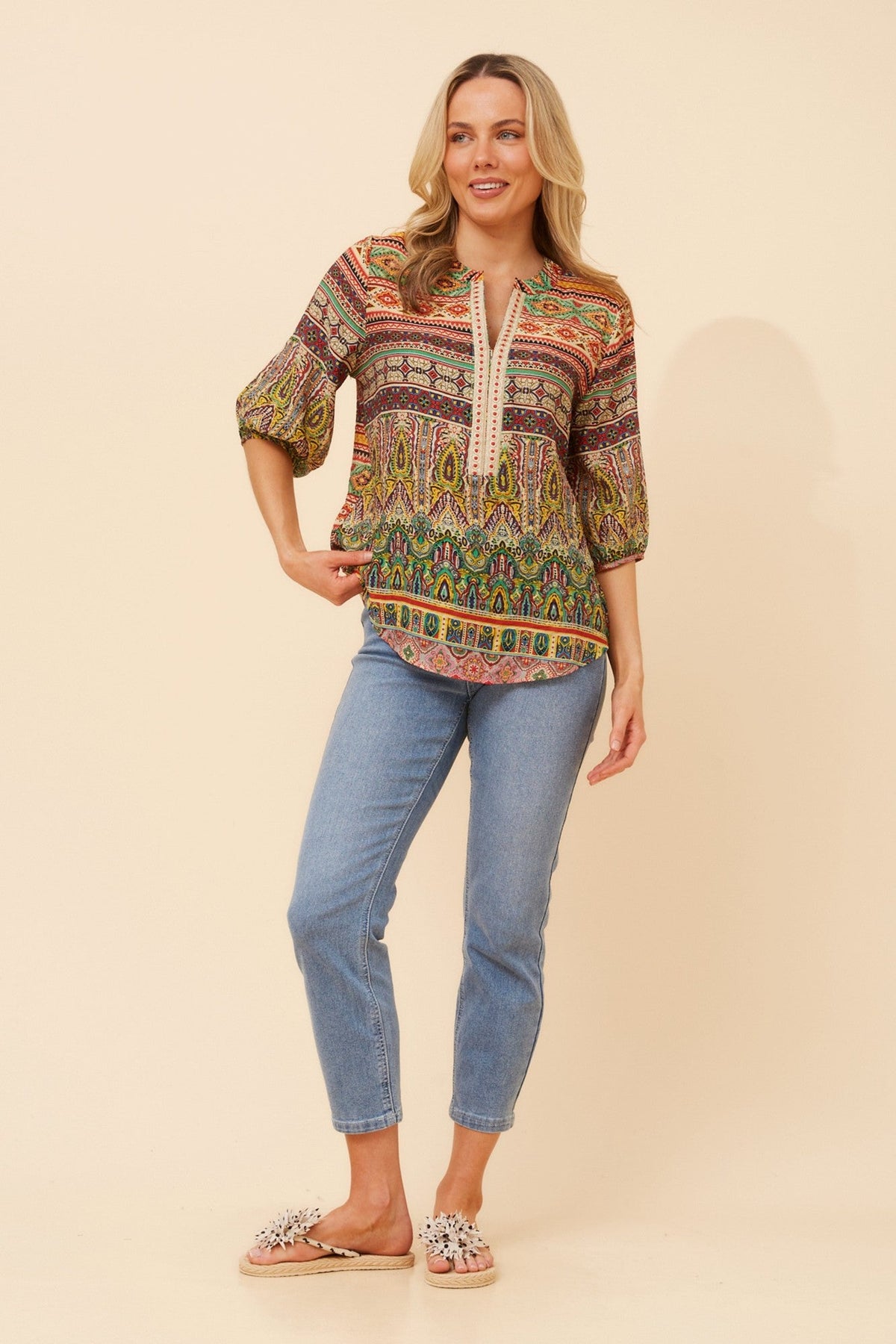 Image of a model wearing Tops. Product name - YANAE BORDER PRINT TOP in Multi Green colour by brand - Caroline Morgan Australia