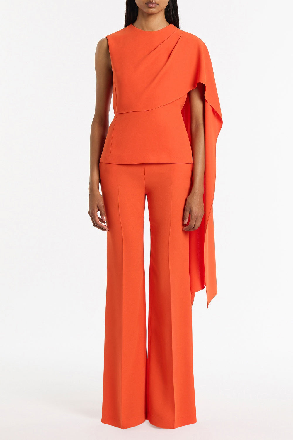 Image of a model wearing Tops. Product name - Tangerine Crepe Cascade Top in Orange colour by brand - Carla Zampatti
