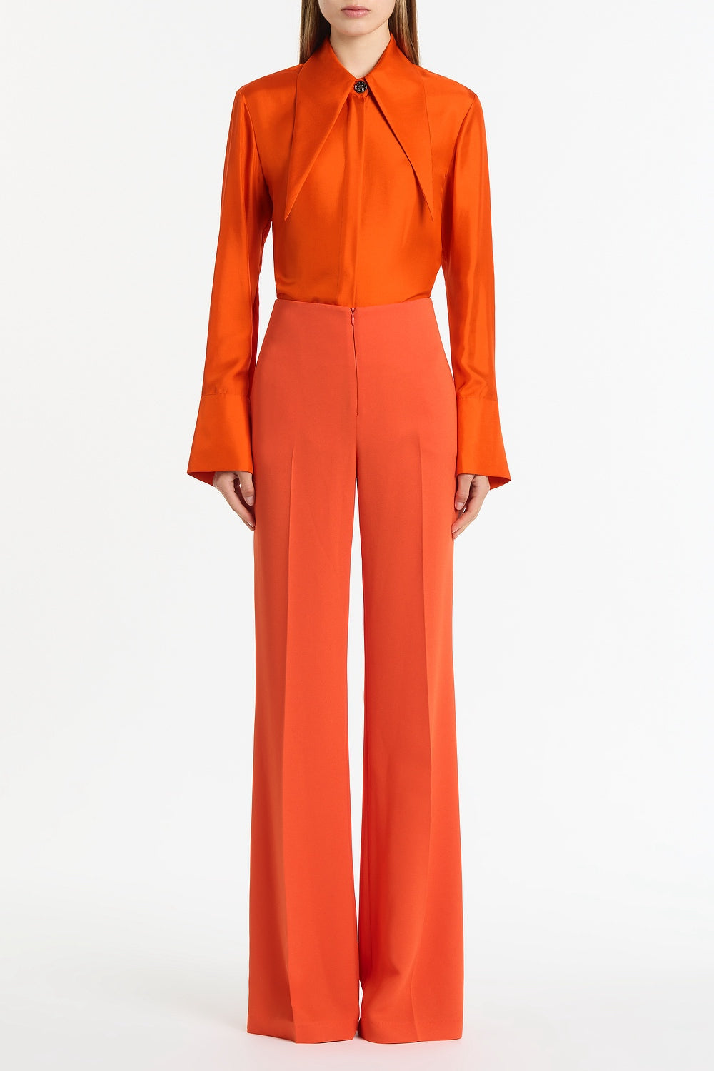 Image of a model wearing Tops. Product name - Tangerine Silk Twill Long Collar Shirt in Orange colour by brand - Carla Zampatti