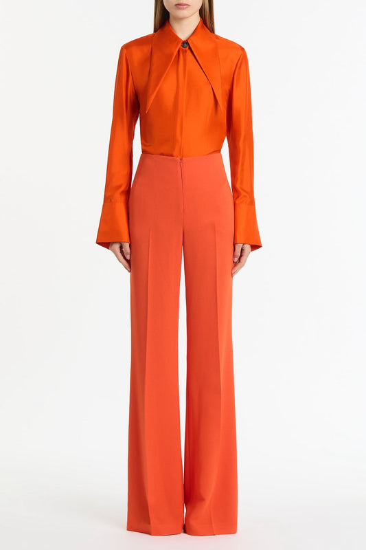 Image of a model wearing Tops. Product name - Tangerine Silk Twill Long Collar Shirt in Orange colour by brand - Carla Zampatti
