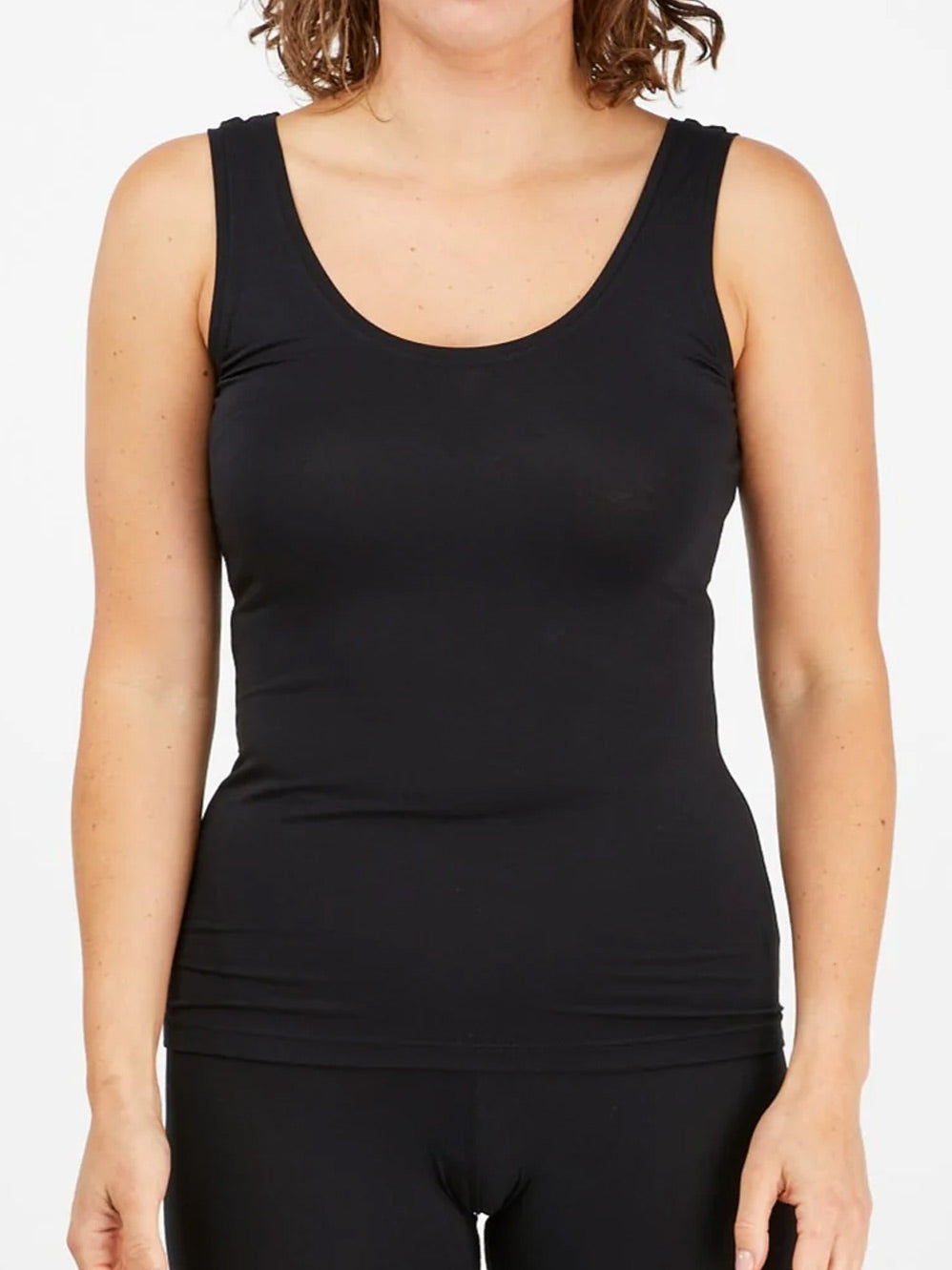 Image of a model wearing Tops. Productname: TANI SCOOP TANK in Black colour by brand - Tani