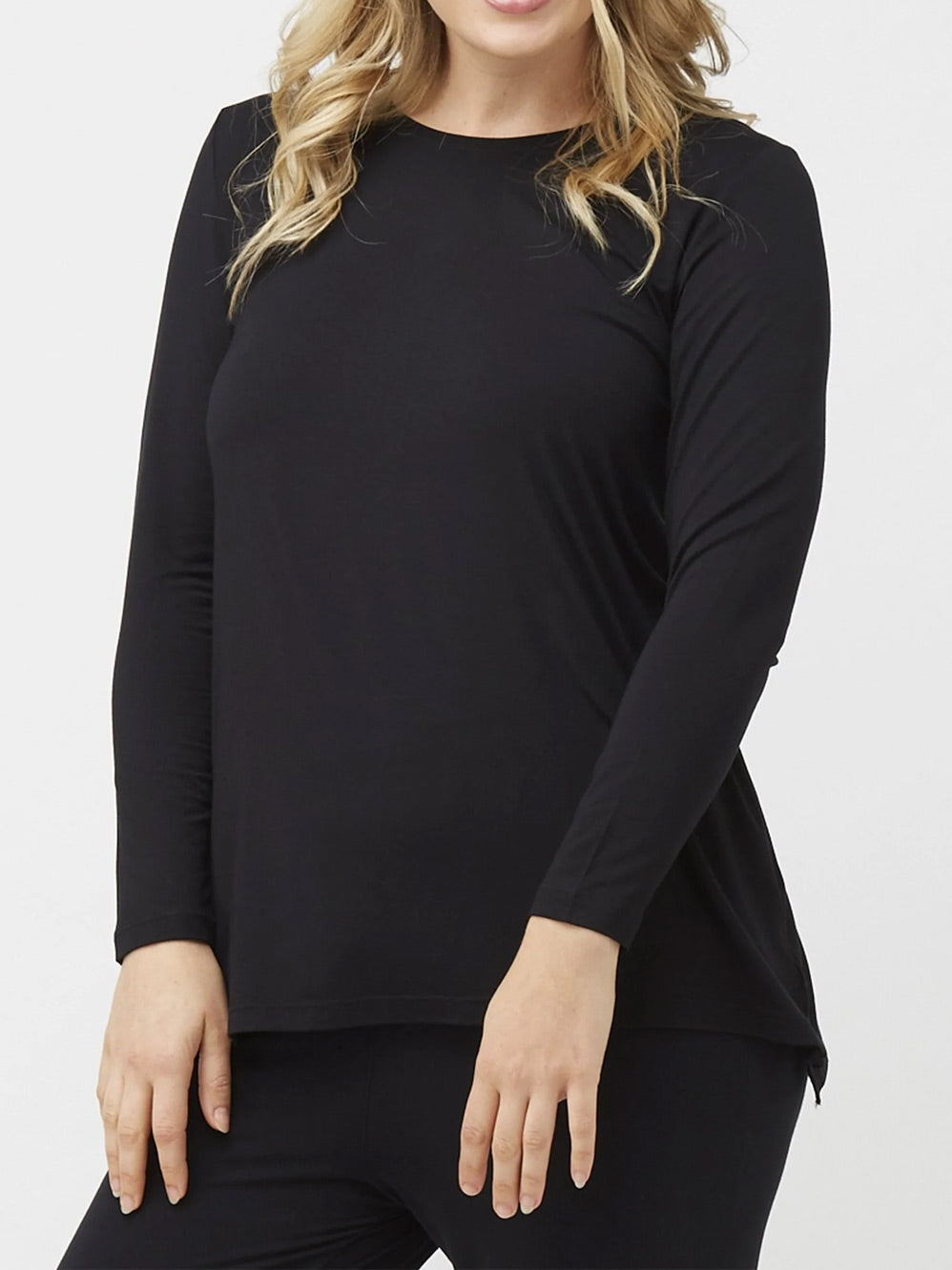 Image of a model wearing Tops. Productname: TANI LONG SLEEVE SWING TOP in Black colour by brand - Tani