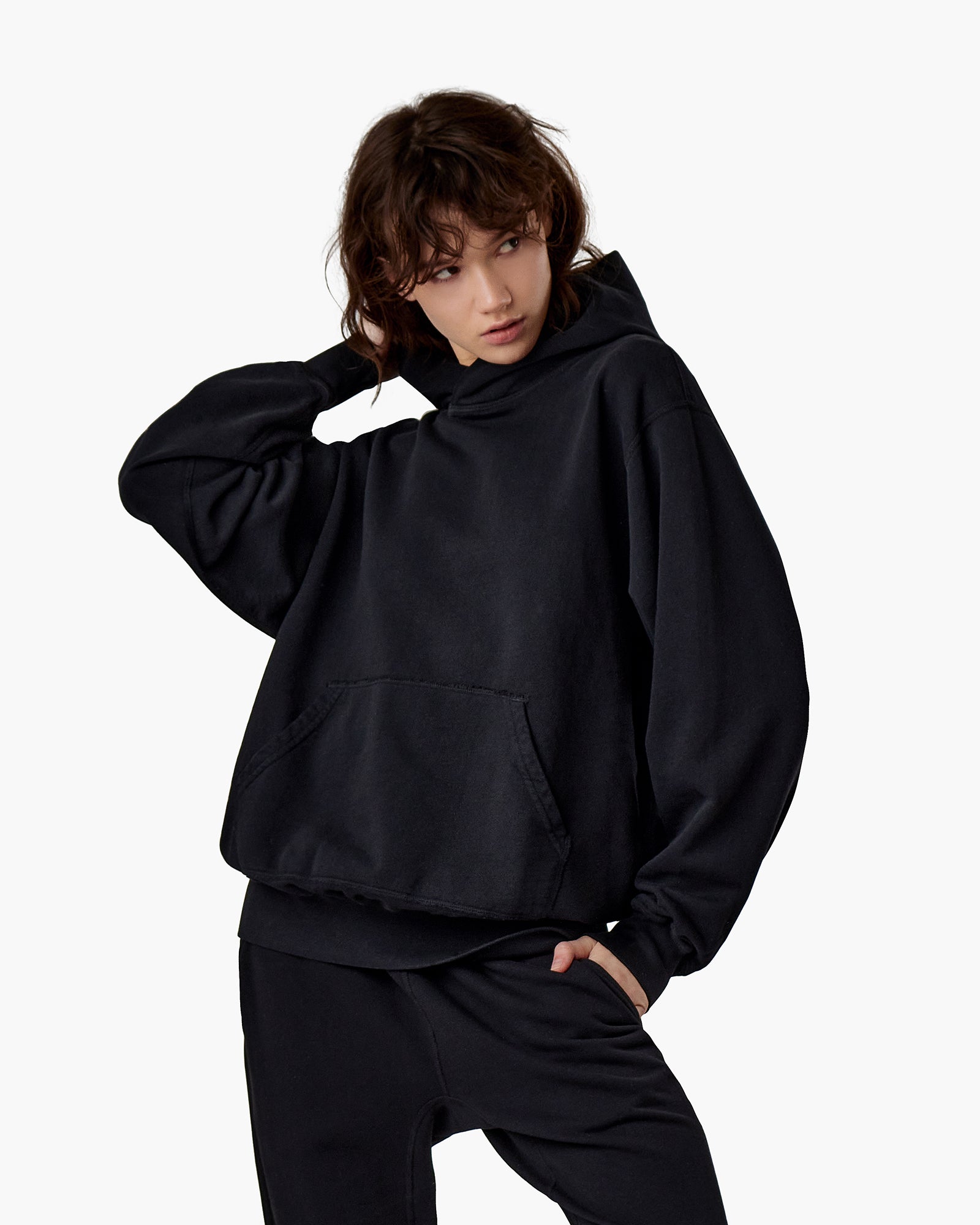 Image of a model wearing Outerwear. Productname: Core Hoodie Black in Black colour by brand - TKEES