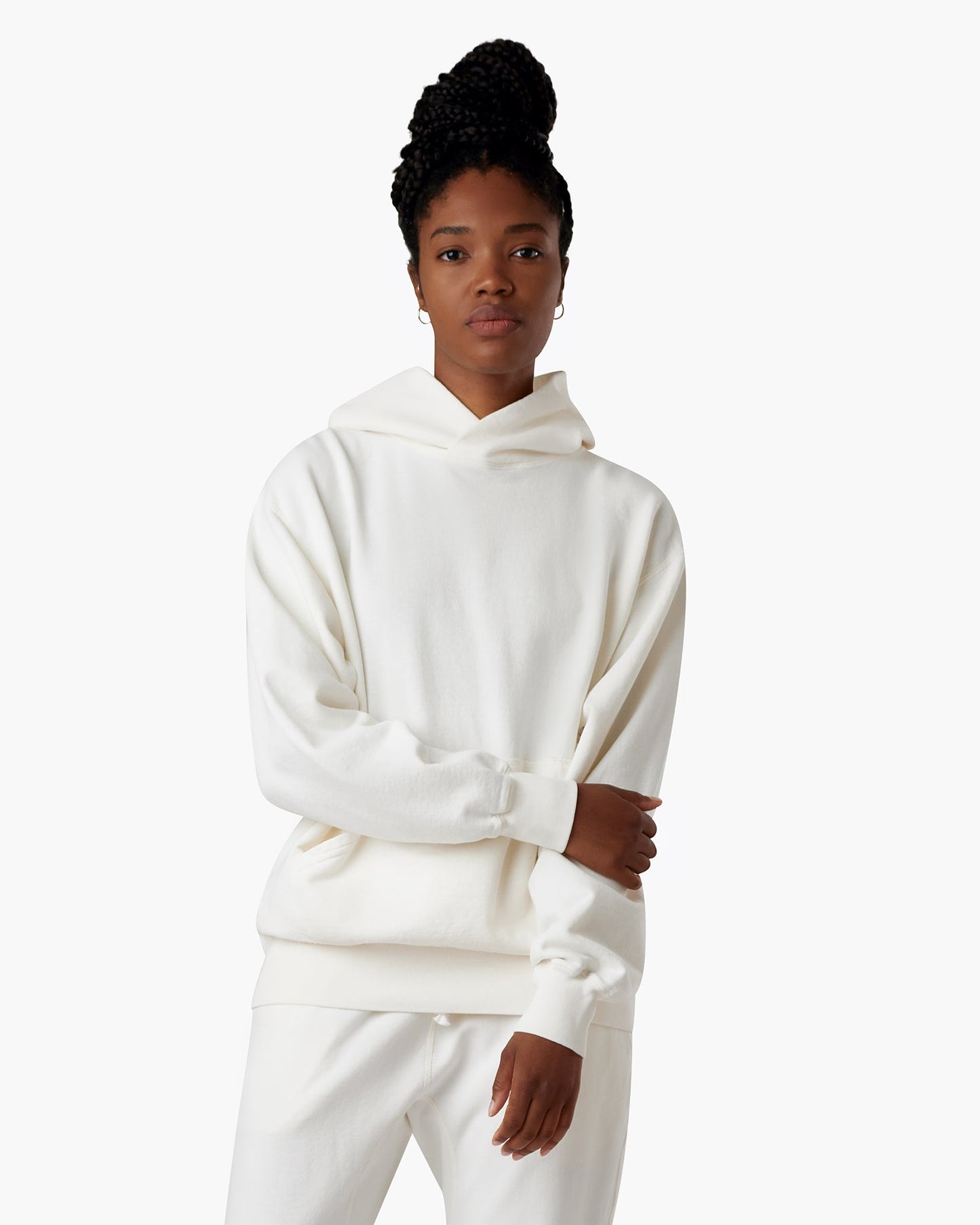 Image of a model wearing Outerwear. Productname: Core Hoodie Cream in Cream colour by brand - TKEES
