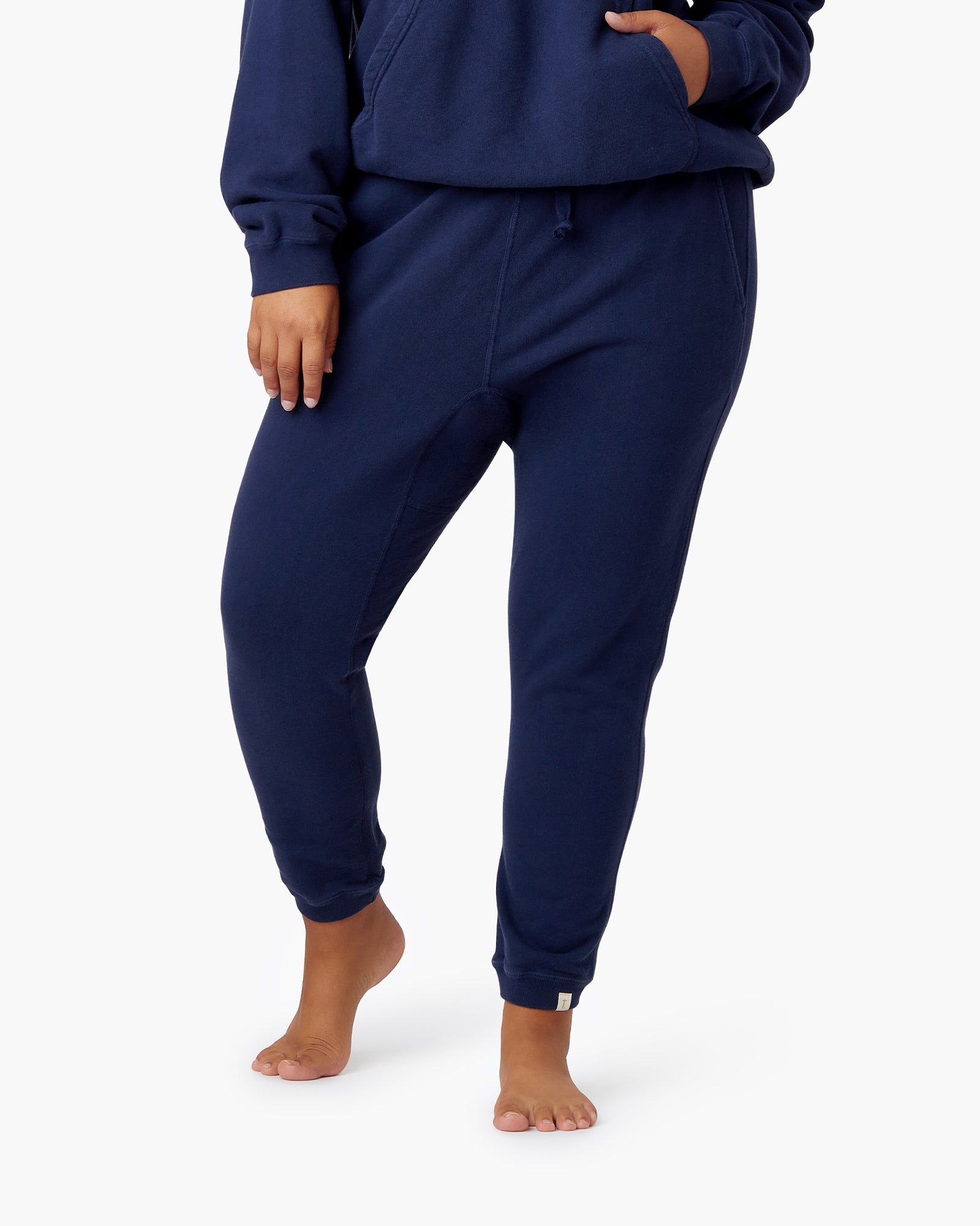 Image of a model wearing Pants. Productname: Core Jogger Navy in Navy colour by brand - TKEES