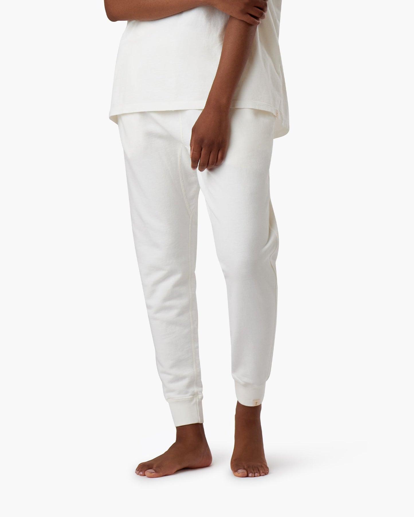 Image of a model wearing Pants. Productname: Core Sport Jogger Cream in Cream colour by brand - TKEES