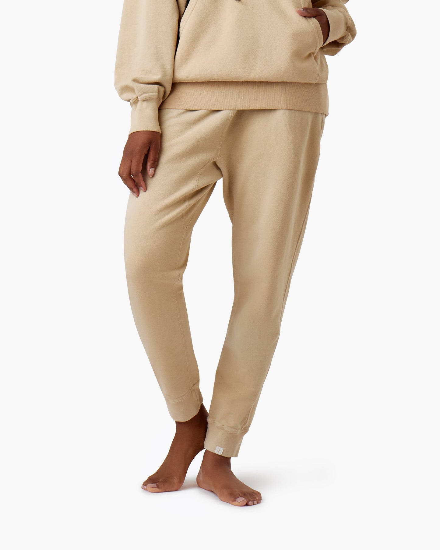 Image of a model wearing Pants. Productname: Core Sport Jogger Latte in Latte colour by brand - TKEES