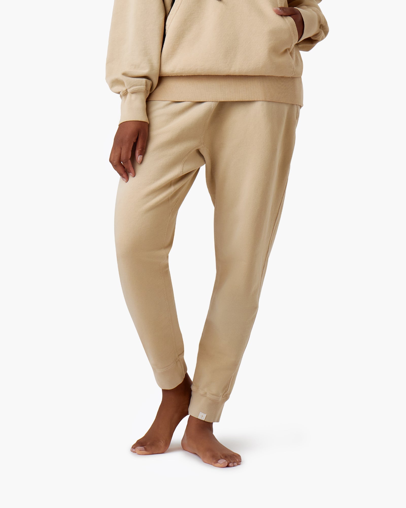 Image of a model wearing Pants. Productname: Core Sport Jogger Latte in Latte colour by brand - TKEES