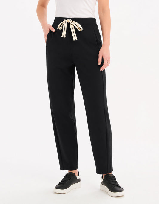 Image of a model wearing Pants. Product name - Barrel Leg Lounge Pant Black / Cream Stripe in Black / Cream Stripe colour by brand - Tirelli