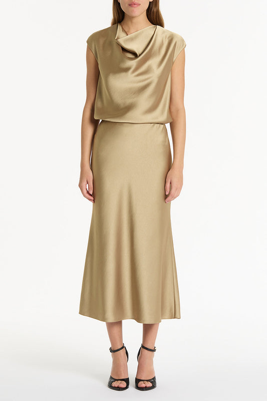 Image of a model wearing Tops. Product name - Tourmaline Satin Cowl Neck Top in Gold colour by brand - Carla Zampatti