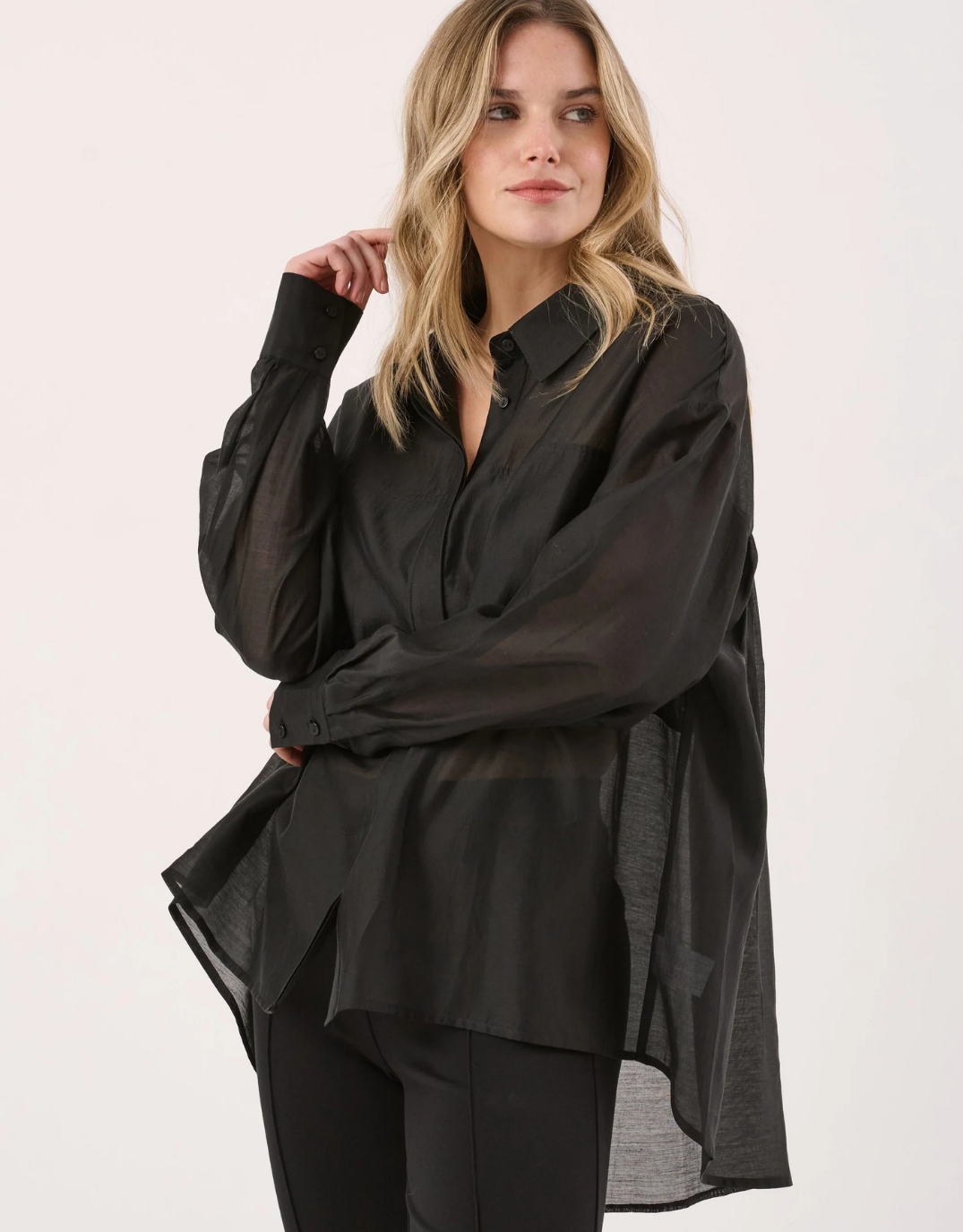 Image of a model wearing Tops. Product name - Val Oversized Shirt Black in Black colour by brand - Sass Clothing