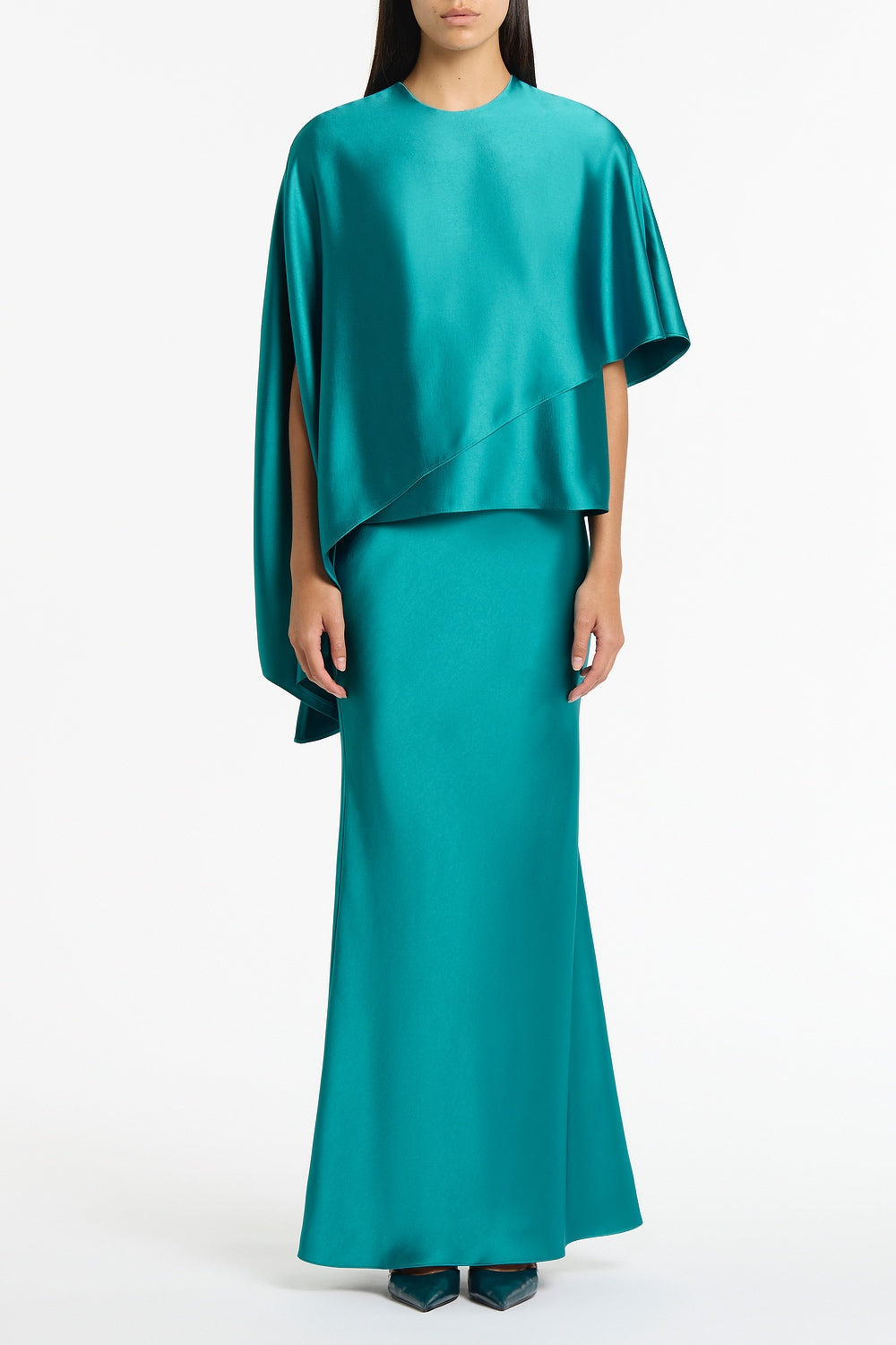Image of a model wearing Tops. Product name - Viridian Lustre Satin Asymmetric Drape Top in Green colour by brand - Carla Zampatti
