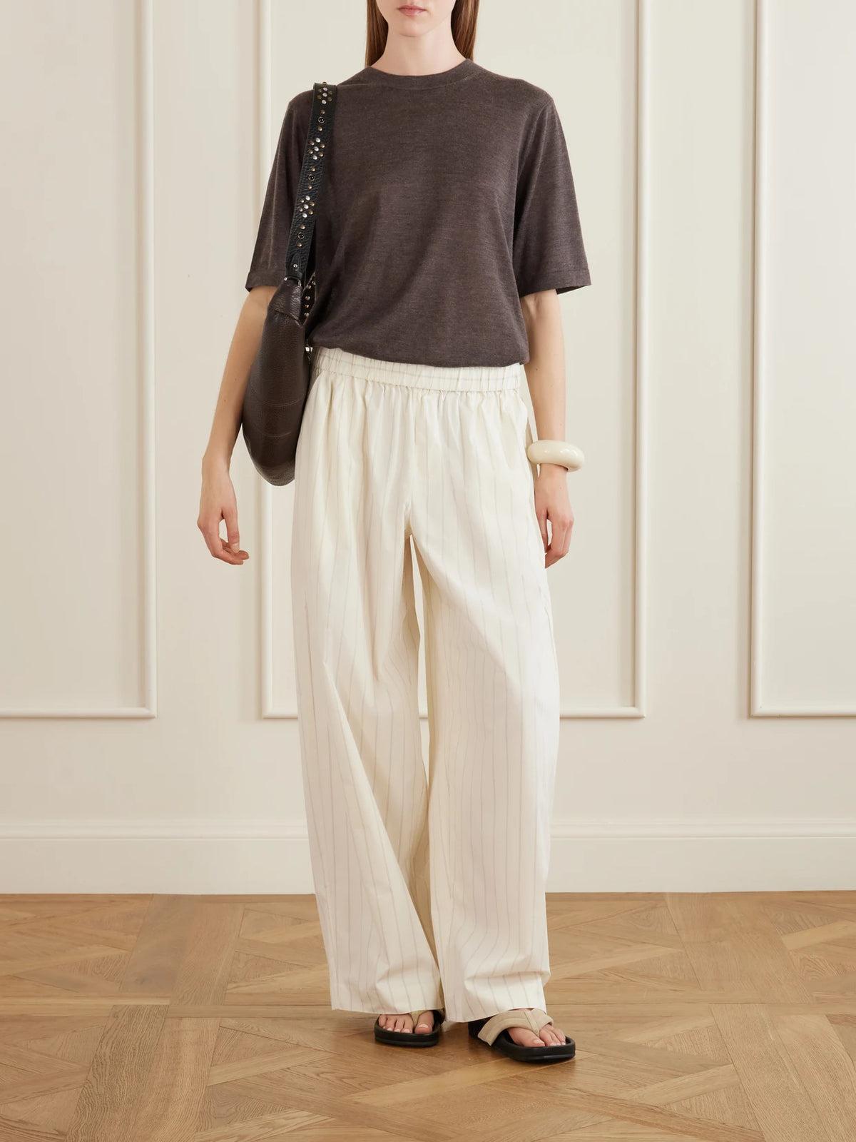 Image of a model wearing Pants. Product name - Everyday Striped Cotton-blend Poplin Wide-leg Pants in Ecru colour by brand - ST. AGNI