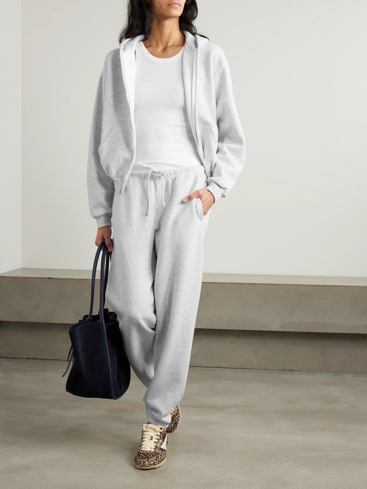 Image of a model wearing Outerwear. Product name - Classic Zip Up Hoodie - Light Heather Grey in Light gray colour by brand - SKIMS