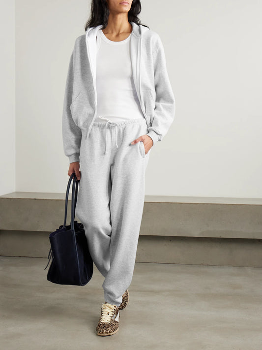 Image of a model wearing Outerwear. Product name - Classic Zip Up Hoodie - Light Heather Grey in Light gray colour by brand - SKIMS