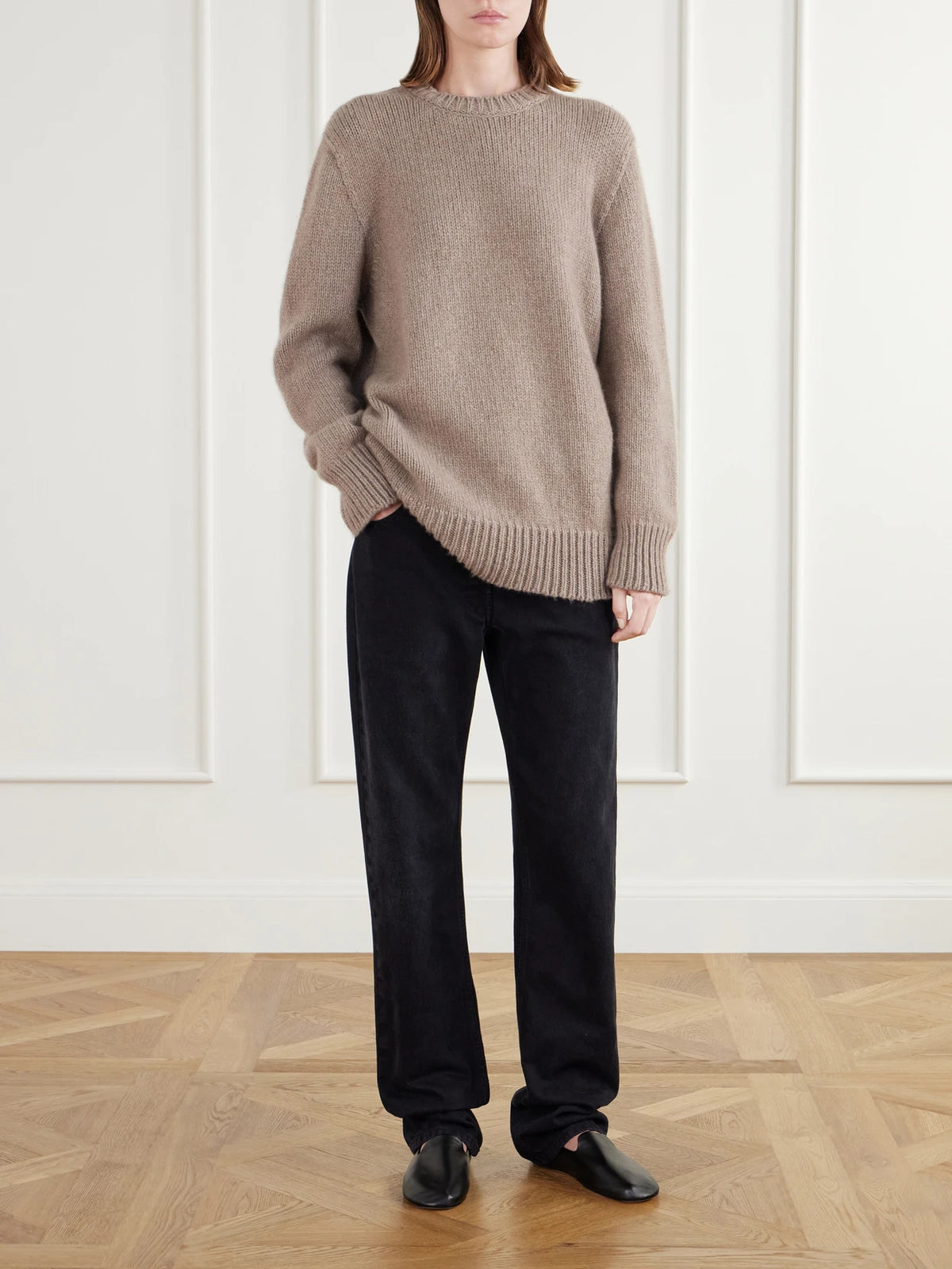 Image of a model wearing Outerwear. Product name - Torin Cashmere Sweater in Sand colour by brand - The Row