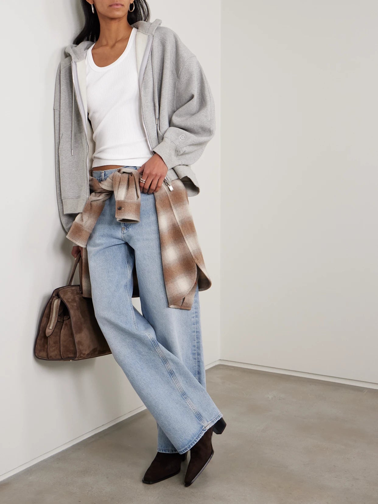Image of a model wearing Tops. Product name - Poppy Ribbed Stretch Organic Cotton And Lyocell-blend Jersey Tank in White colour by brand - AGOLDE