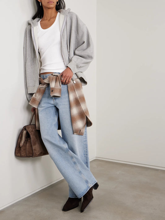 Image of a model wearing Tops. Product name - Poppy Ribbed Stretch Organic Cotton And Lyocell-blend Jersey Tank in White colour by brand - AGOLDE