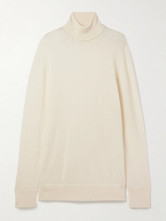 Image of a model wearing Outerwear. Product name - Lizzy Oversized Cashmere Turtleneck Sweater in Ivory colour by brand - The Row