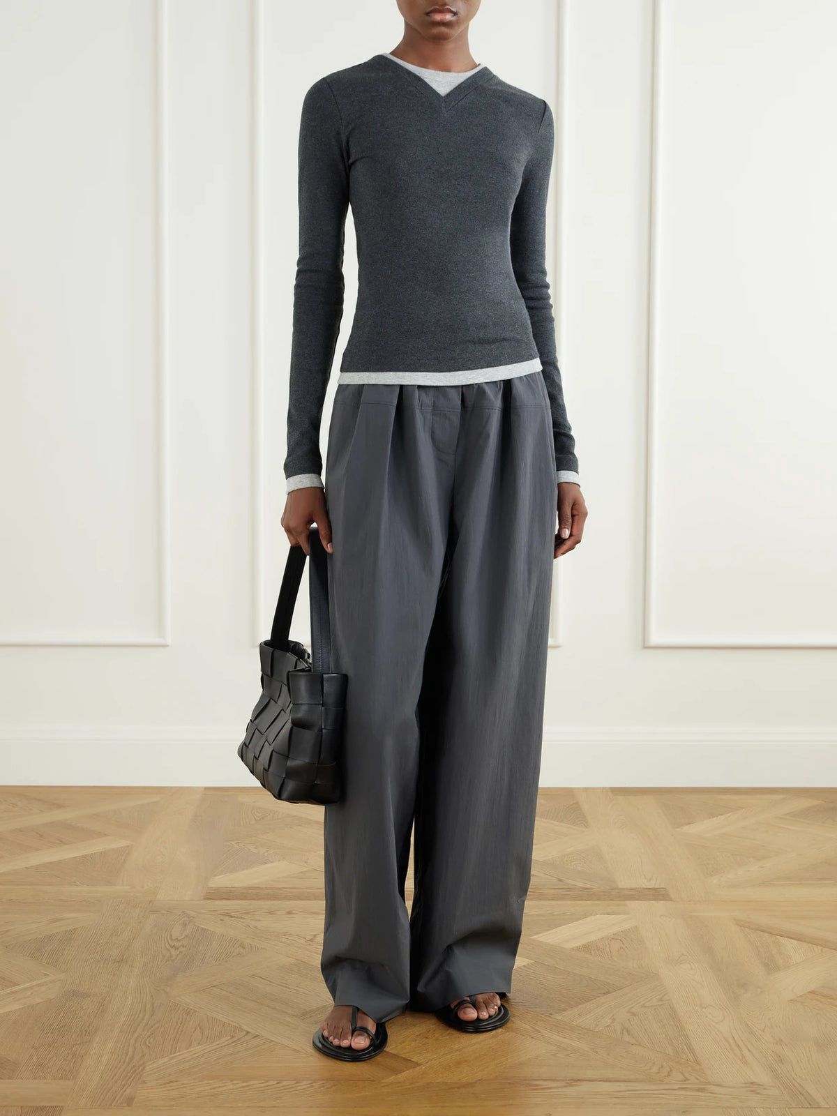 Image of a model wearing Pants. Product name - Pleated Cotton-blend Shell Wide-leg Pants in Anthracite colour by brand - ST. AGNI