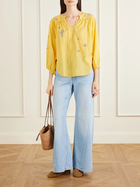 Image of a model wearing Tops. Product name - The Breeze Embroidered Cotton-blend Voile Blouse in Yellow colour by brand - Mother