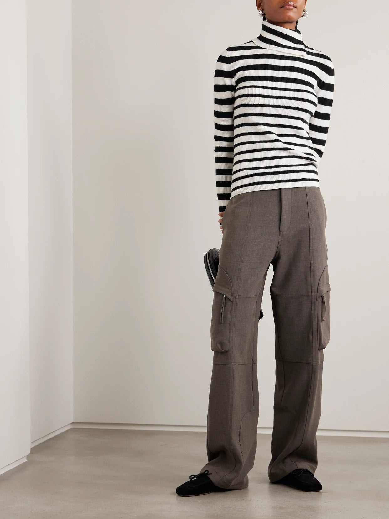 Image of a model wearing Outerwear. Product name - Sabrine Button-detailed Striped Ribbed Cotton And Cashmere-blend Turtleneck Sweater in Black colour by brand - LISA YANG