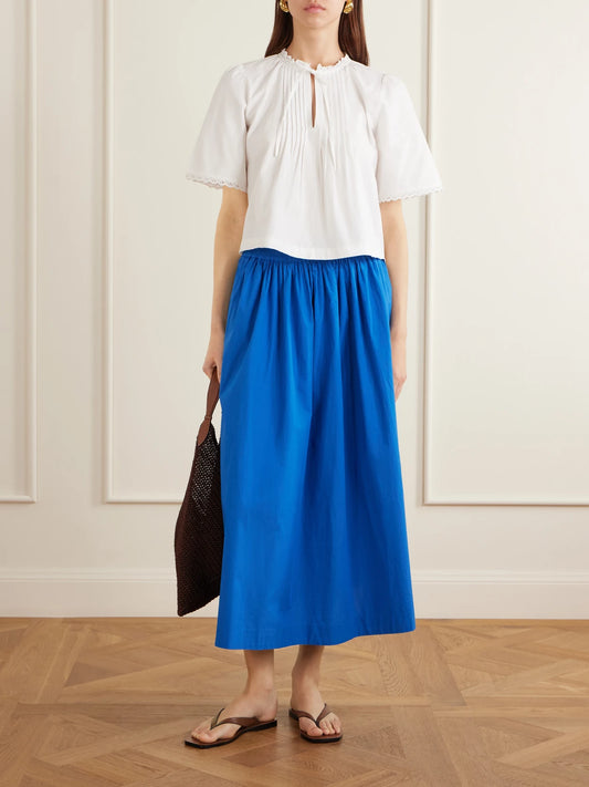 Image of a model wearing Tops. Product name - Freesia Pleated Lace-trimmed Organic Cotton Shirt in White colour by brand - SKALL