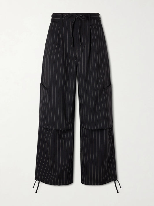 Image of a model wearing Pants. Product name - + Y-3 Pinstriped Recycled Woven Wide-leg Pants in Black colour by brand - adidas Originals