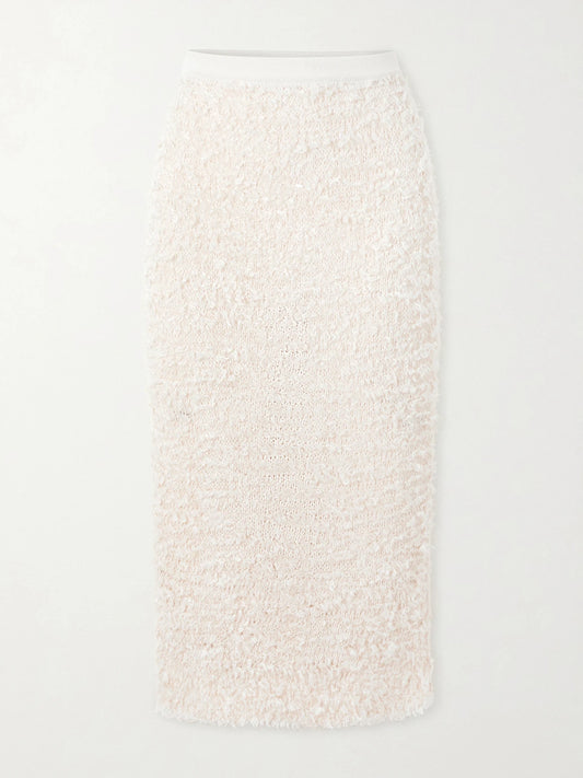 Image of a model wearing Skirts. Product name - Adela Bouclé Midi Skirt in Ivory colour by brand - KHAITE